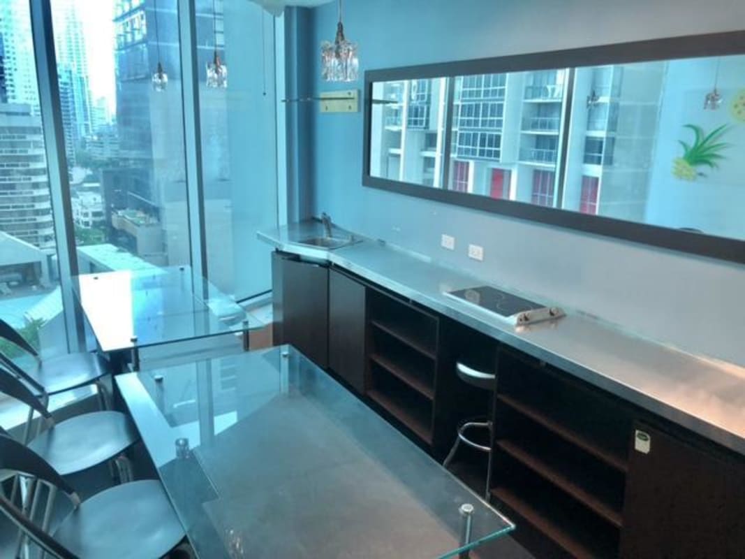Kitchenette dining area with floor to ceiling windows overlooking city skyline Ocean Business Plaza