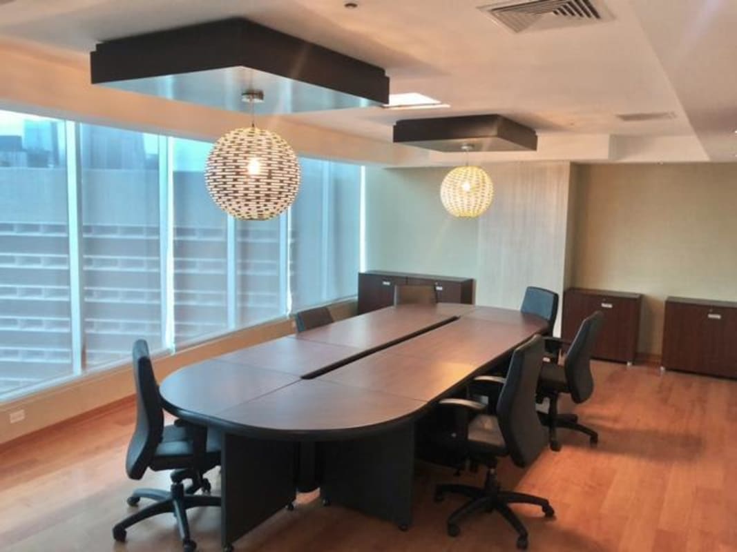 Spacious corporate conference room with wood floors, large table in Ocean Business Plaza office Panama Marbella