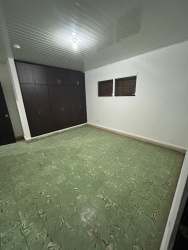 Entry area with black door, large window, tile floor Aurosport building Chitré for rent