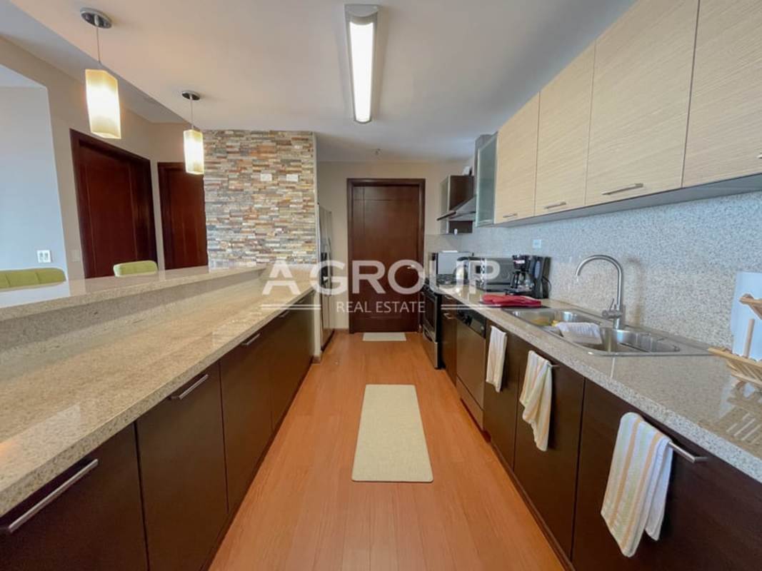 Modern open kitchen with granite countertops and bar at Dupont Tower Punta Pacifica