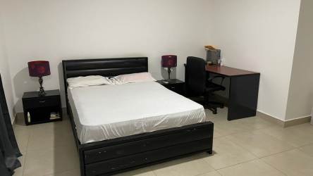Bedroom with black furniture desk workspace Woodlands townhouse Panama Pacifico