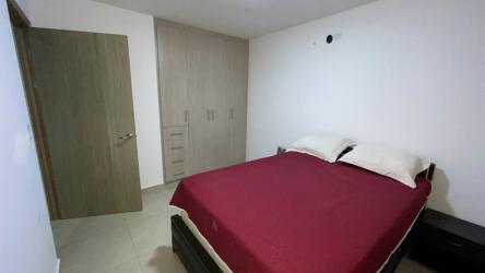 Bedroom with red bedspread, built-in wardrobe Woodlands townhouse Panama Pacifico