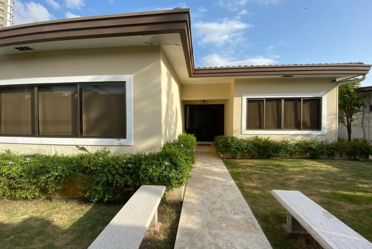 Spacious living area with large sectional, marble floors in El Carmen residence Panama