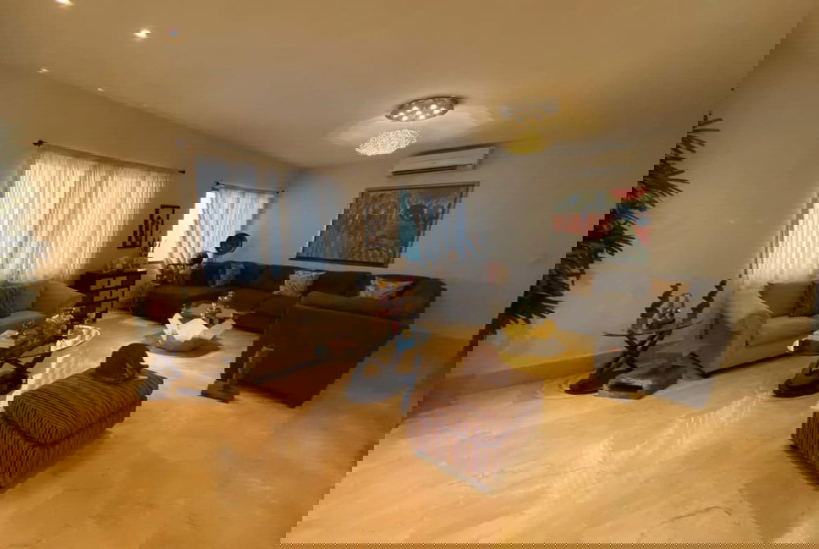 Contemporary living room with marble flooring, large windows sheer curtains, art decor El Carmen house Panama