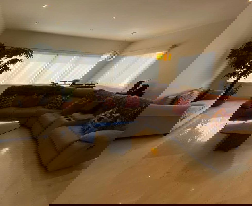 Modern open-plan living dining area with marble floors, large windows in El Carmen house Panama City