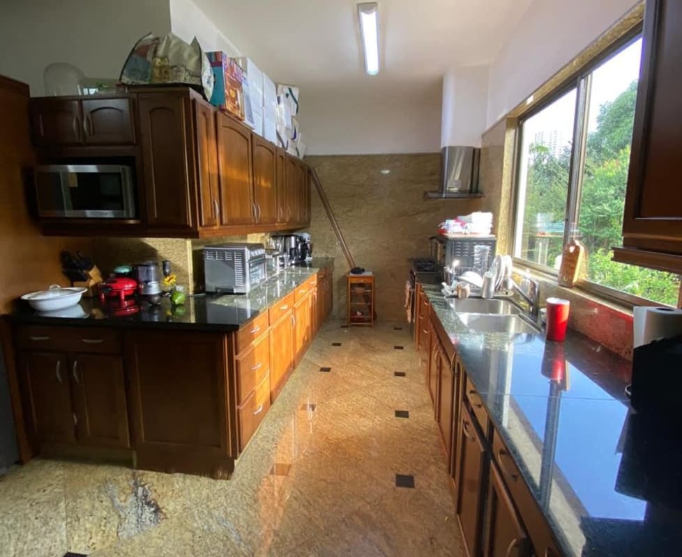 Kitchen with granite counters, island, wood cabinets, stainless steel fridge El Carmen home