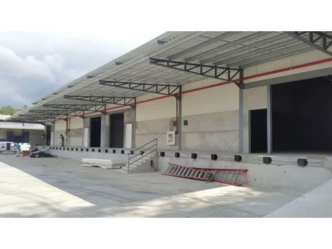 Industrial warehouse facility with multiple loading bays canopy roof parking area in Milla 8 Panama