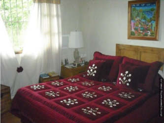 Bedroom with handcrafted wood cabinets and mountain view Altos del María Panama house