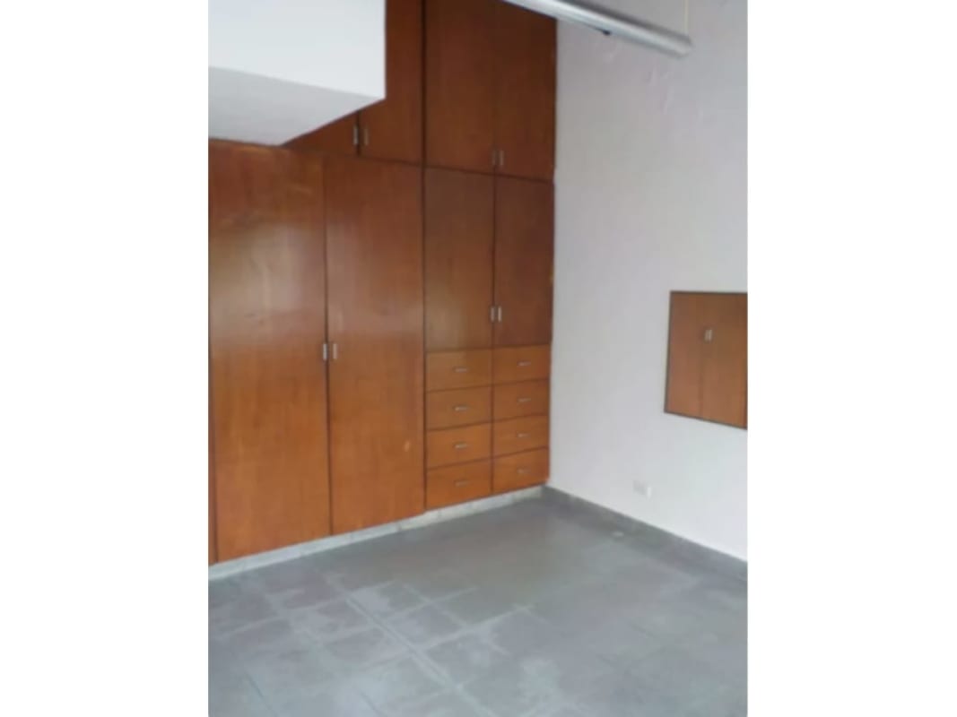 Bedroom empty with large wooden built-in wardrobes gray tile floor Coco del Mar Panama