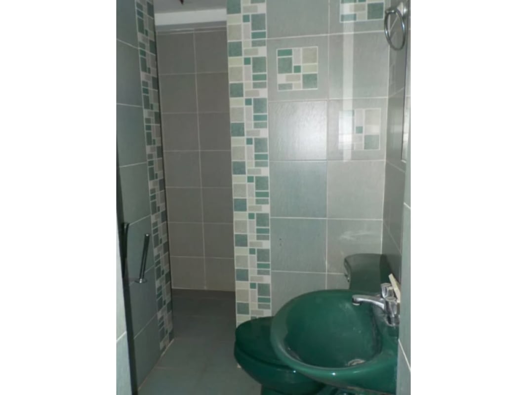 Bathroom featuring green sink and toilet, mosaic accents walk-in shower luxury house Panama