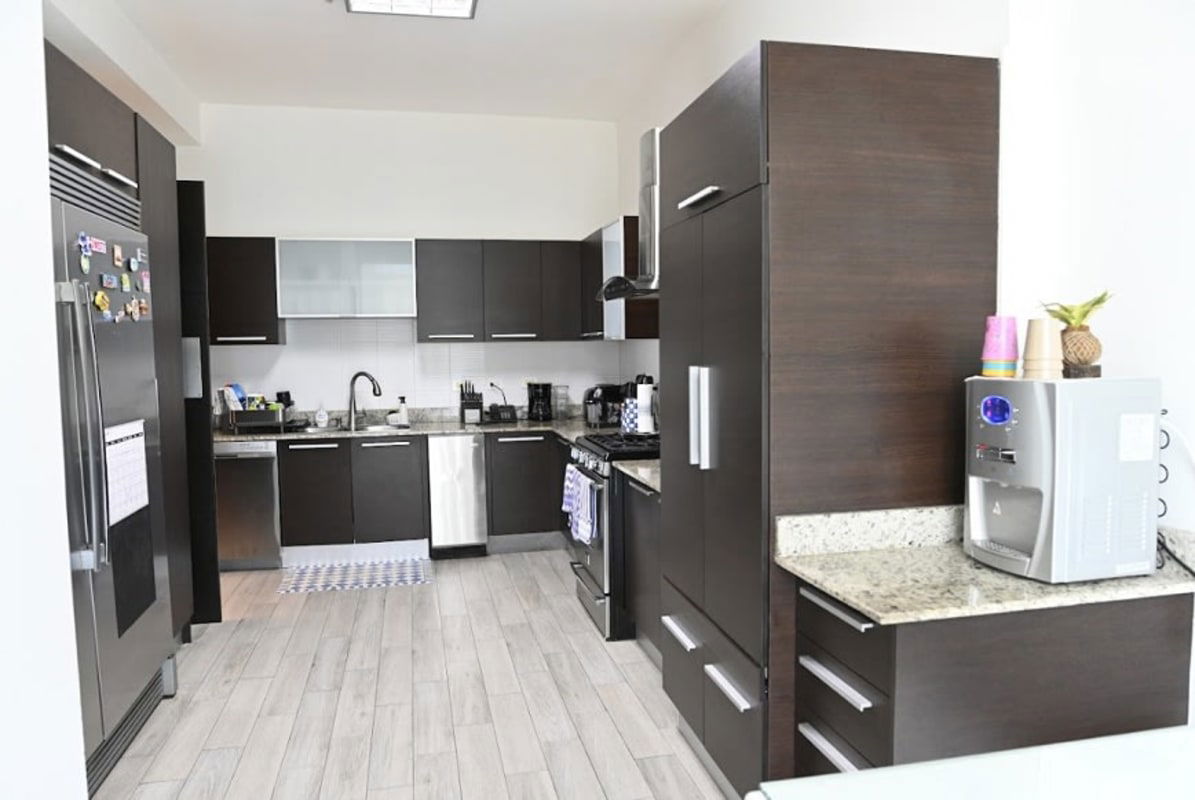 Contemporary kitchen with granite counters and stainless appliances in PH Titanium Costa del Este Panama