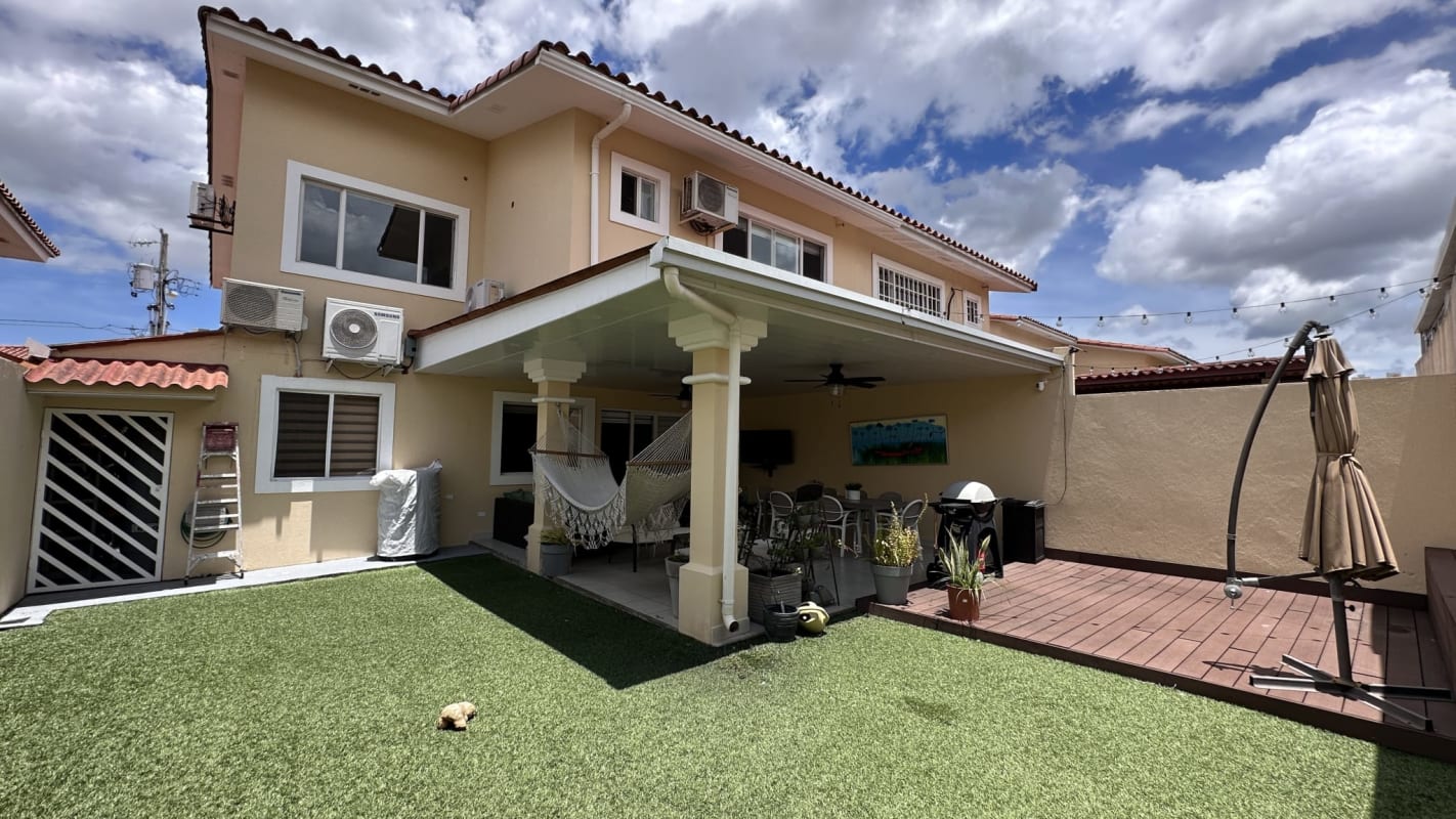 Bright open plan living dining with beige sofa and glass table duplex house brisas del golf Panama