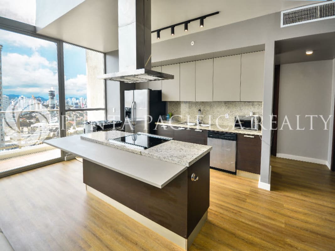 Modern kitchen with granite countertops and stainless appliances in PH Oceanaire Panama City