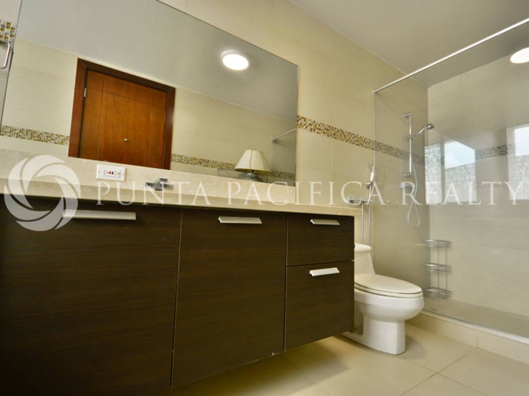 Modern bedroom with large windows, ocean skyline view, hardwood floors, Punta Pacifica Panama