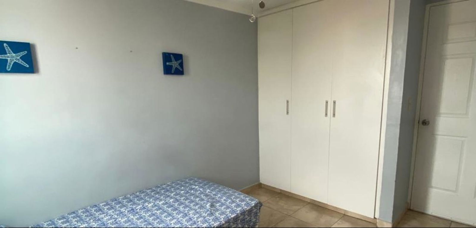 Furnished minimalist bedroom with air conditioning, ceiling fan in PH Girasol PL Parque Lefevre