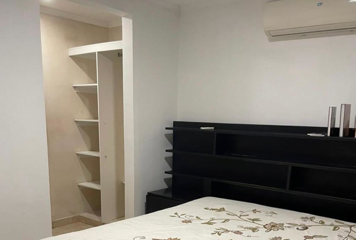 Bedroom featuring walk-in closet, air conditioning unit and storage shelves in PH Girasol PL