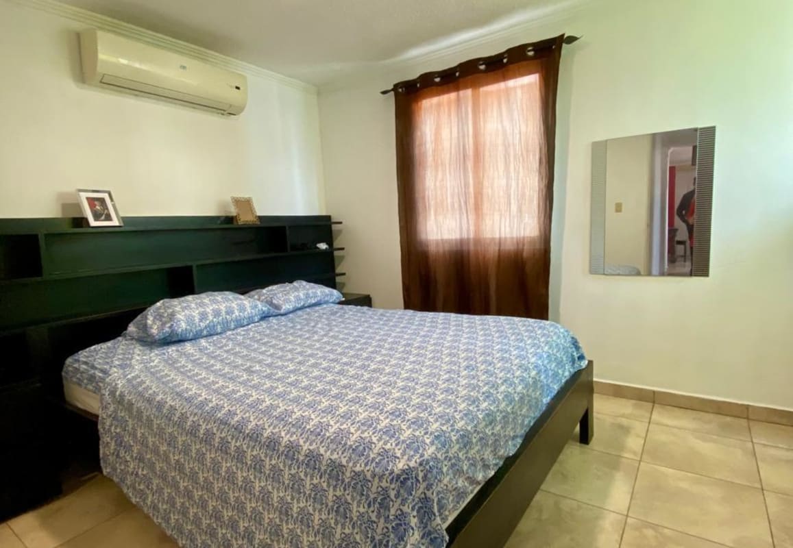 Bedroom with AC, curtain window, shelved headboard, blue bedding in PH Girasol PL