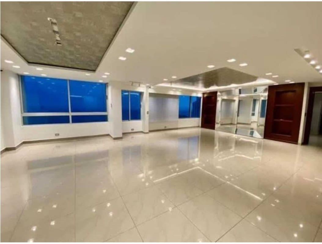 Sleek kitchen with granite island countertop and panoramic windows overlooking the ocean in PH Terrasol San Francisco