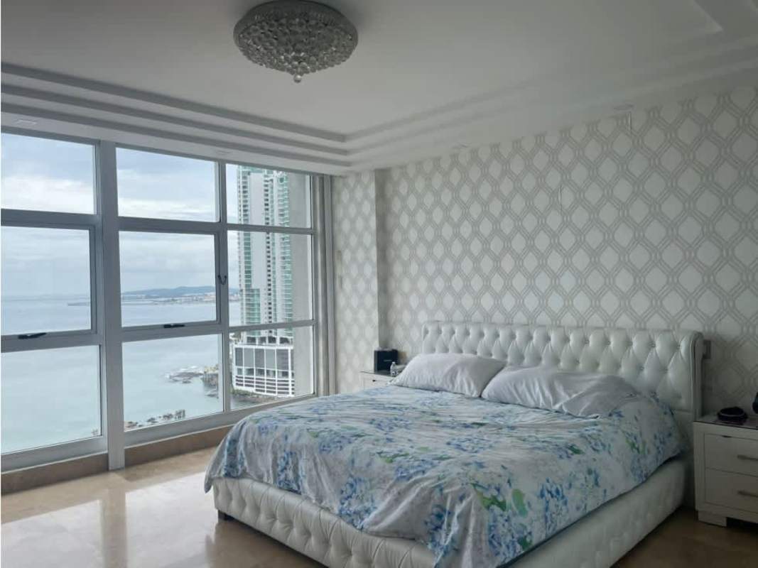 Luxury waterfront condo bedroom with large windows and city views PH Q Tower Panama