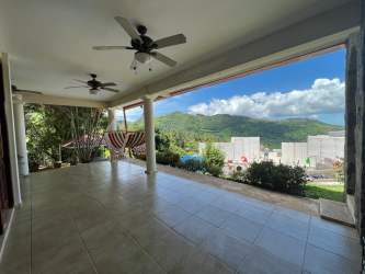 Spacious covered terrace with ceiling fans, hammocks, mountain landscape in Altos del María Panama