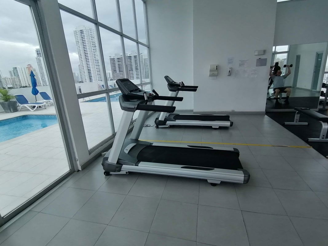 Indoor gym with city view floor-to-ceiling windows PH Marina Plaza Panama