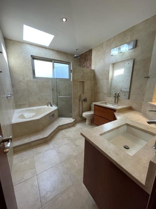 Modern bathroom with bathtub, dual vanity sinks PH Embassy Gardens luxury house for rent Clayton Panama