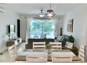 Bright open living dining with beige sofas and modern kitchen PH Terrazas de Farallón Playa Blanca Panama