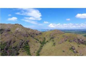 Aerial lush green mountain valley flowing down to Pacific beaches at Punta Chame Panama