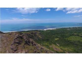 Drone coastline photo featuring mountain ridge, green forest and ocean at Playa Caracol Punta Chame