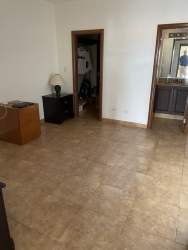 Covered patio terrace with pool lush garden and golf course views luxury villa in Tucan Country Club Panama