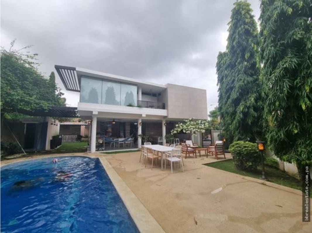 Covered patio with BBQ, seating, overlooking pool in PH Fuentes del Fresno Altos de Panama Panama