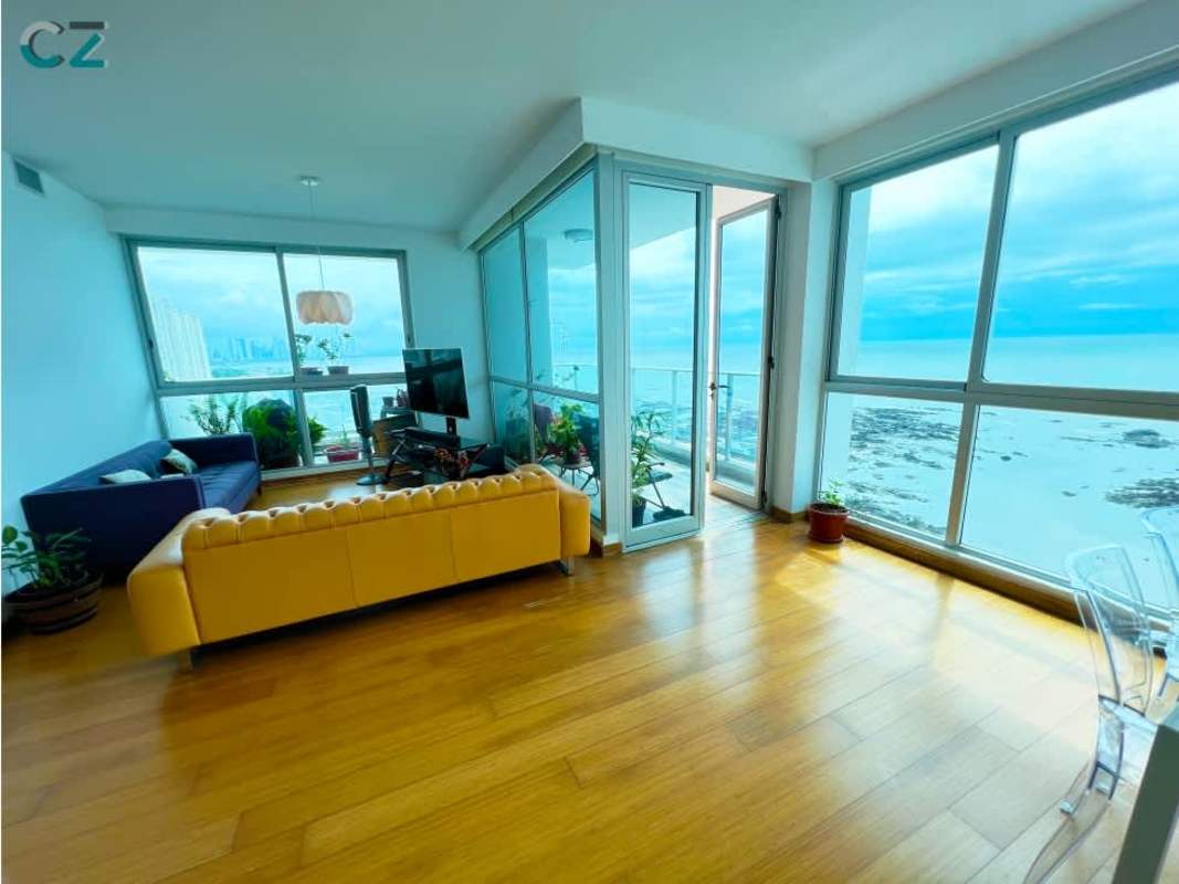 Modern living room floor-to-ceiling windows terrace ocean view Oceanaire Punta Pacífica Panama City