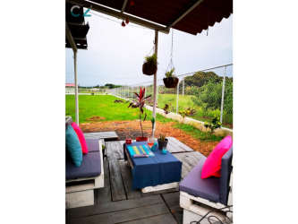 Portable pool setup in fenced grassy backyard near Pacific beaches in Panama