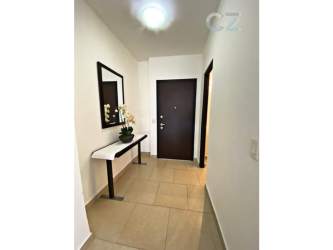 Contemporary bedroom with wood flooring, large window, roller shade, ceiling fan in PH Soleo Panama Pacifico