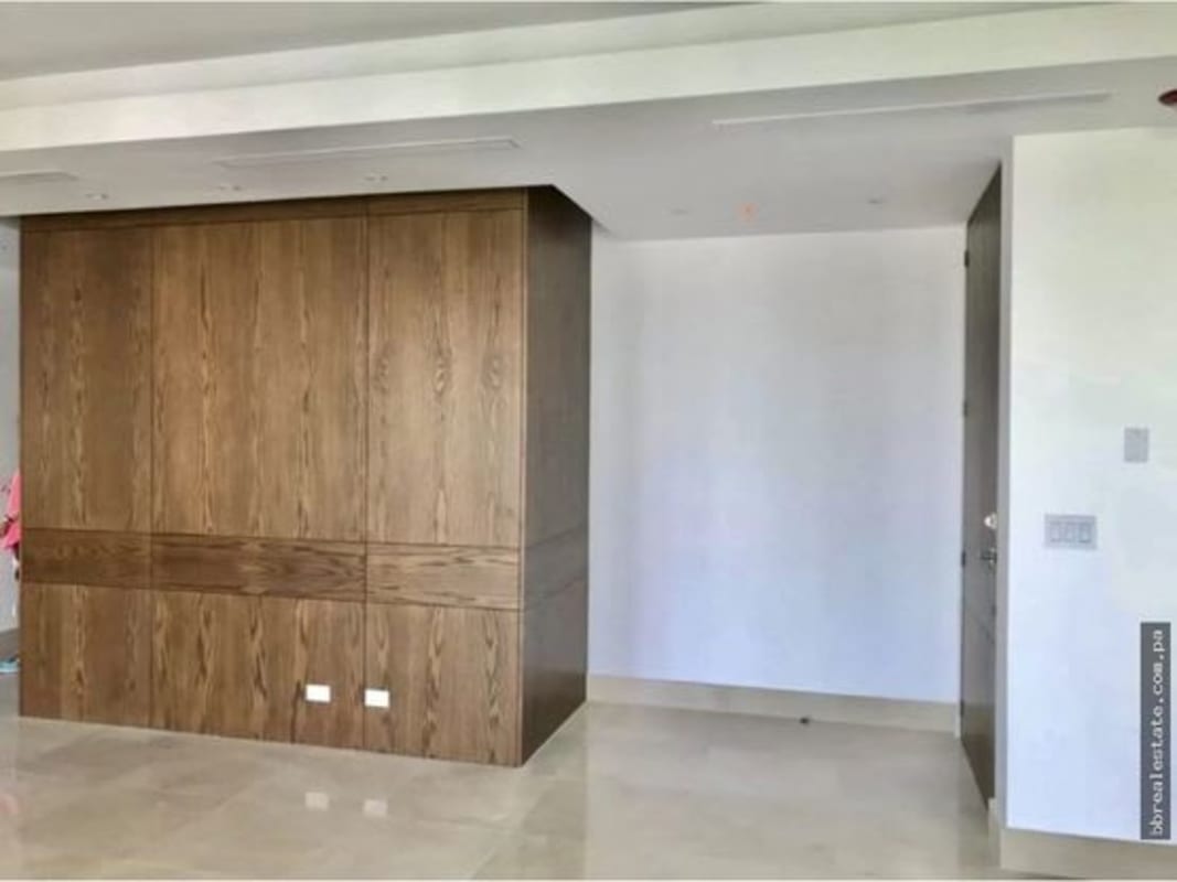 Wide modern living room with floor to ceiling windows and ocean views at PH Aria Costa del Este Panama City