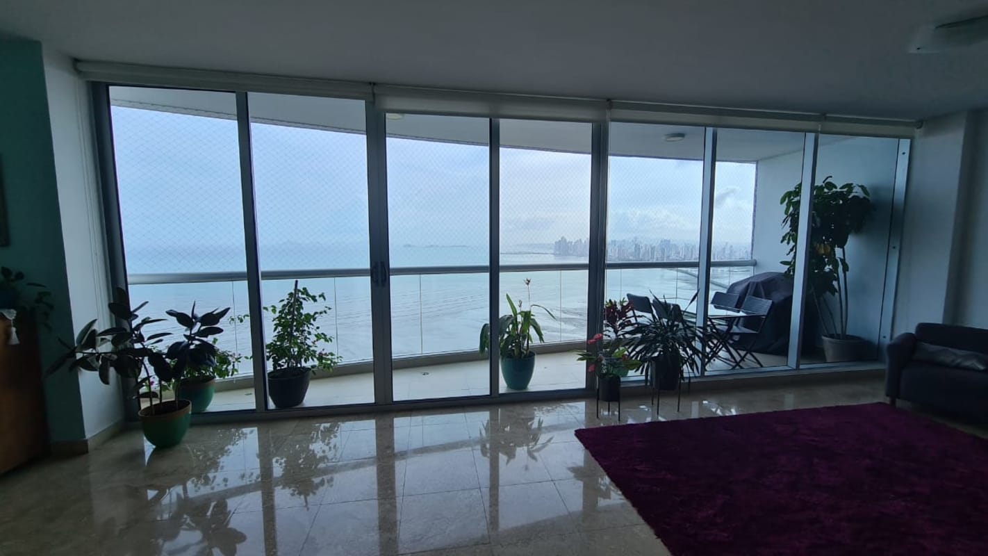 Spacious living room with ocean view balcony floor-to-ceiling windows PH Pearl on the Sea Panama
