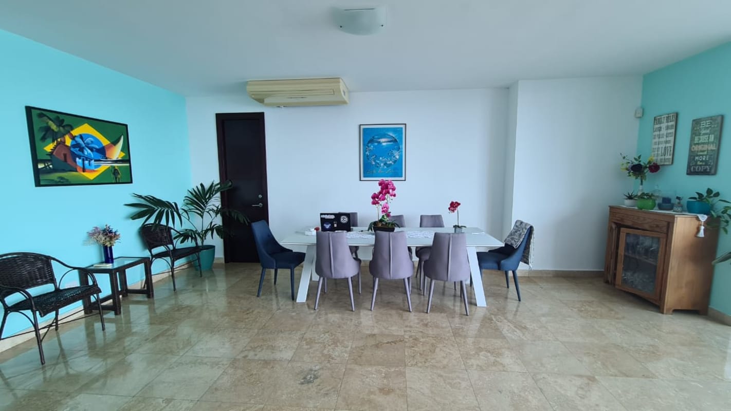 Dining room with blue wall large table modern decor at PH Pearl on the Sea Panama