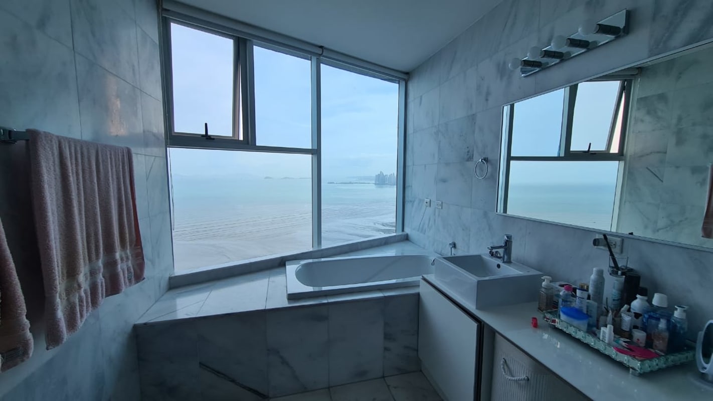 Bathroom with marble finishes bathtub large window with sea view in PH Pearl Costa del Este Panama