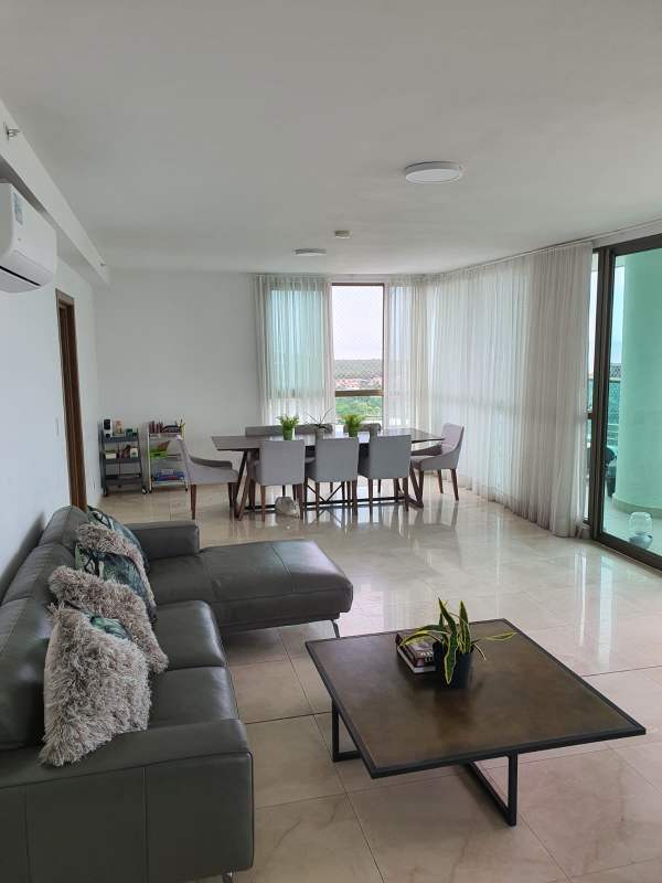 Luxury apartment living room with sectional sofa, colorful pillows and large windows PH Park Lane Costa del Este