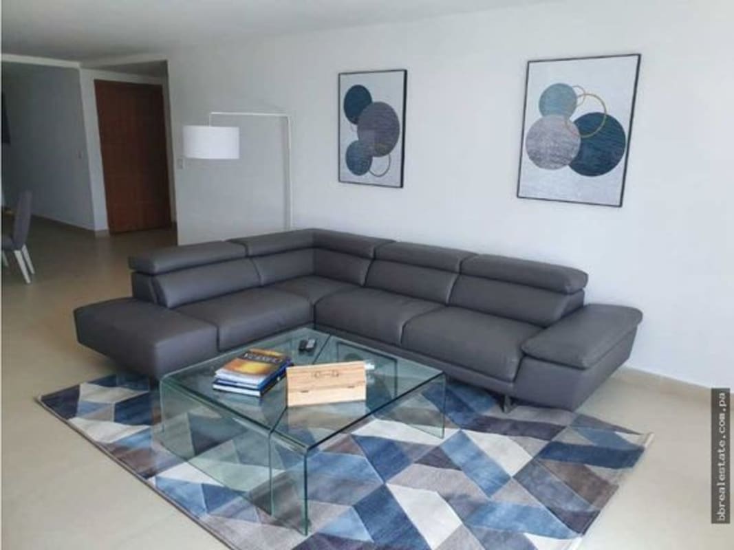 Spacious living room with sectional sofa, floor-to-ceiling windows, ocean views in PH Isla Naos Causeway Amador Panama