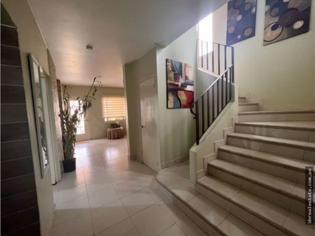 Contemporary staircase and hallway with window blinds and art in Quintas de Versalles Panama