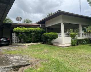 House exterior with porch, covered carport, landscaped garden Bugaba estate
