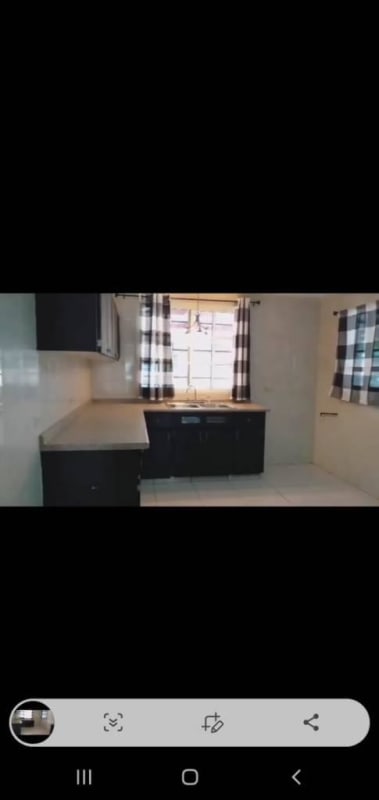 Black cabinets, ceramic backsplash, modern fixtures in residential kitchen Panama