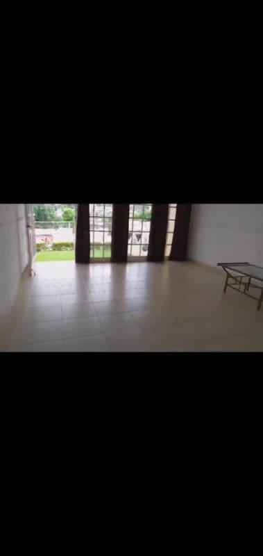 Spacious living room open concept with large windows and tile flooring in Alto del Bosque house Panama