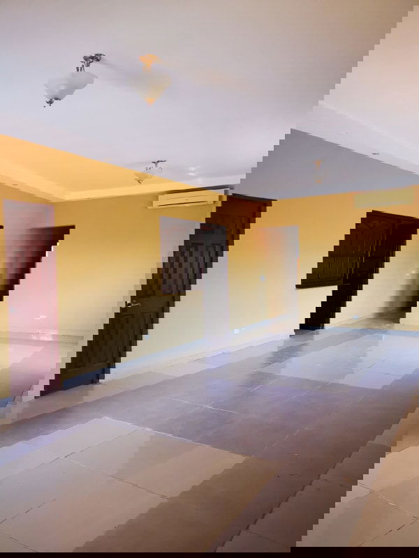 Covered terrace overlooking large backyard with garden in Las Cumbres Panama City