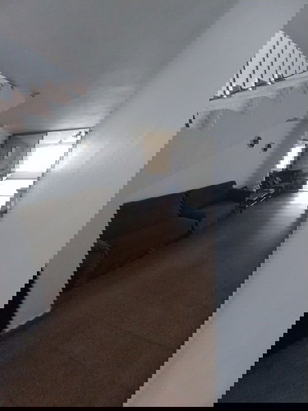 Bright living room with ceramic tile floors, ceiling fan, and large window in duplex Pedregal