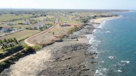 Coastal oceanfront vacant land palm trees sandy beach at Playa Venao Panama