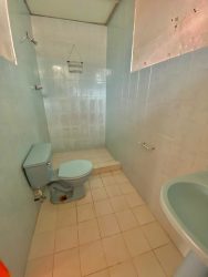 Basic tiled bathroom with shower toilet and sink in house Fuente del Chase Panama