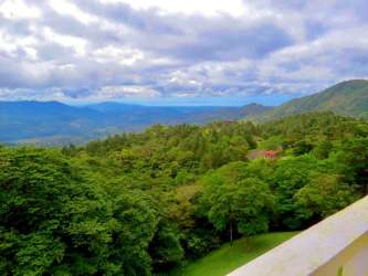 Mediterranean design house with tile roof, balcony, garden and mountain backdrop Panama Altos del María