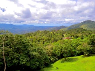 Panoramic mountain and forest views from balcony with railing at Altos del María estate Panama